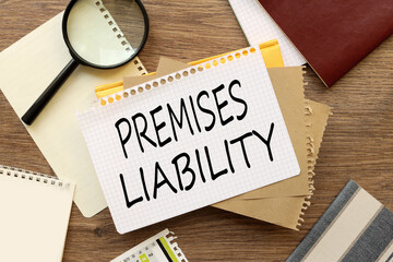 Office desk with notepad and supplies. View from above. Copy space for text. Premises liability