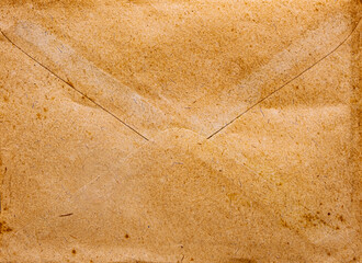 front view closeup of blank old aged closed letter paper envelope with torn edges from 1900