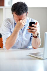 Business man, laptop and phone with stress, headache and thinking for finance review, mistake or tired. Accountant, pc and smartphone with burnout, fatigue or mental health with fail, glitch or error