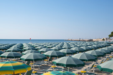 parasols on the sandy beach in Manfredonia town, - obrazy, fototapety, plakaty