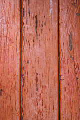 Naklejka premium The background of the wall with the texture of boards painted with red paint
