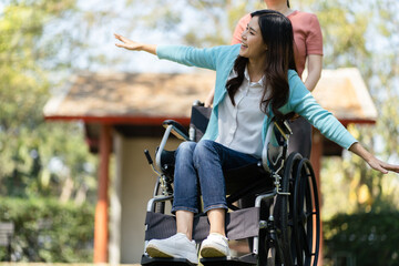Young asian woman in wheelchair with positive thinking. - obrazy, fototapety, plakaty