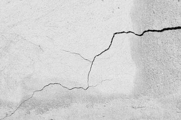 An old wall with a cracked texture is decorated with cement mortar