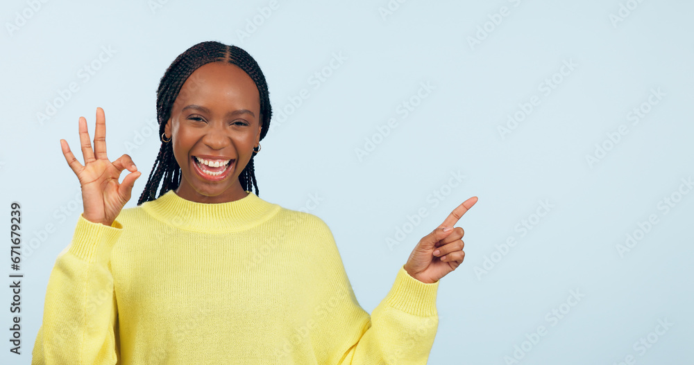 Canvas Prints Pointing, portrait and black woman with opportunity, ok sign and announcement on a blue studio background. African person, model and girl with hand gesture, mockup space and agreement with feedback