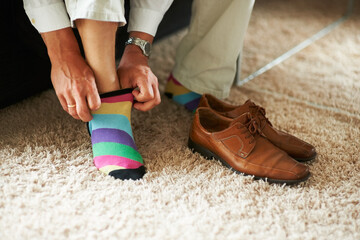 Man getting ready, shoes and socks on carpet in home, putting on business fashion and start to day. Businessman dressing for work in morning, feet on floor with style and wardrobe for office career.