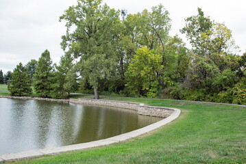 Tree Lined Pond with Flagstone Wall