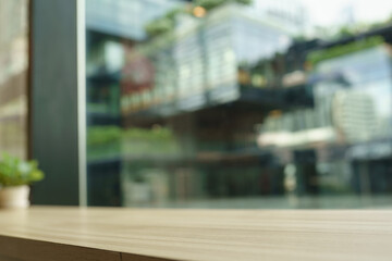 empty wood table by window in town