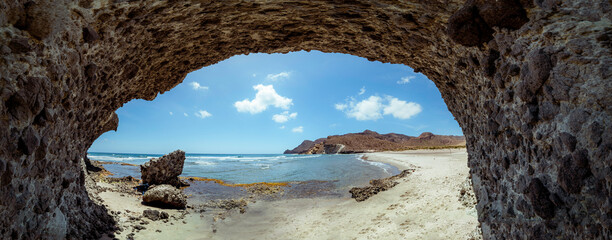 Panoramic photography. Cala de la Media Luna - Cabo de Gata Natural Park, is a cove with fine sand and a quiet environment. People alternate with or without swimsuits, each at their own free choice. 