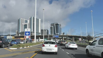 Cape Town, South Africa - September 22, 2023: Slow traffic proceeding toward city, past gore sign 1