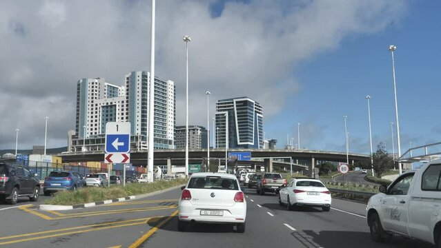Cape Town, South Africa - September 22, 2023: Slow traffic proceeding toward city, past gore sign 1