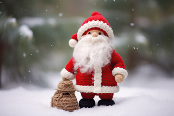 Fototapeta premium crocheted cute Santa Claus standing in the snow