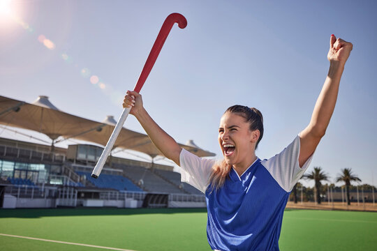 Hockey, winner and athlete woman in celebration after winning or scoring a goal at sports match or game on field. Fitness, win and young champion player happy about performance achievement in sport - Powered by Adobe
