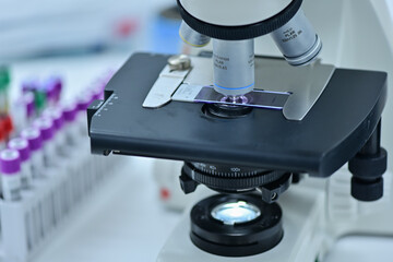 Medical technologist using diagnostic equipment in a cancer hospital lab in Asia