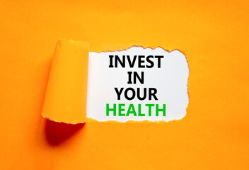 Invest in your health symbol. Concept word Invest in your health on beautiful white paper. Beautiful orange paper background. Invest in your health concept. Copy space.