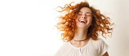 A youthful joyous lady gracefully moving to music in front of a plain white backdrop