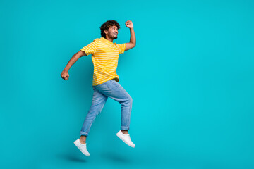 Fototapeta na wymiar Full body profile portrait of crazy sportive person jumping running empty space isolated on turquoise color background