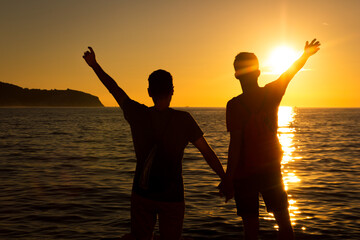 Fototapeta premium Gay pair standing at the sunset
