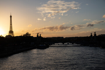 sunset over the river with a silhouette of the Eiffel tower