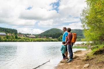 Heterosexual couple with their little daughter having a hiking day around schluchsee lake in Black...