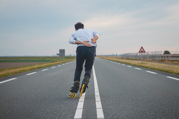 Handsome young athlete rollerblades on Dutch roads to improve endurance and fitness. A young man...
