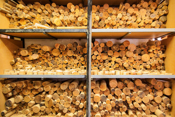 Storage shelves with olive wood blanks prepared for drying in the workshop of an olive wood carver