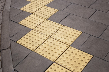 Tactile pavement or braille blocks on the sidewalk on a city street