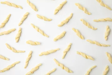 Fototapeten Uncooked trofie pasta on white background, flat lay © New Africa