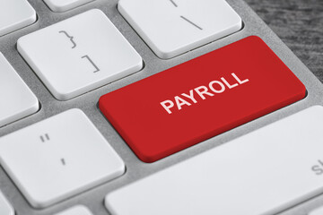 Red button with word Payroll on keyboard, closeup