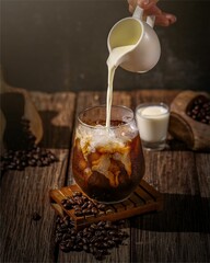 Delicious iced coffee covered in milk adds flavor and is beautiful to look at