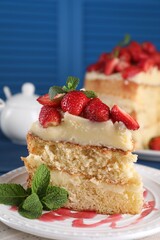 Piece of tasty cake with fresh strawberries and mint on table, closeup