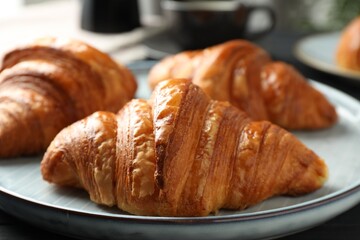 Delicious fresh croissants on dark table, closeup
