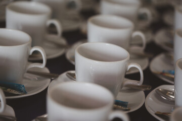 Many empty cups with spoons for service coffee in seminar event or meeting room