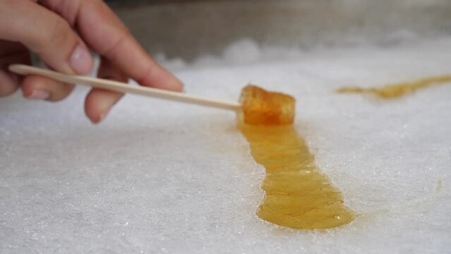 Female Rolling Maple Syrup Towards Camera