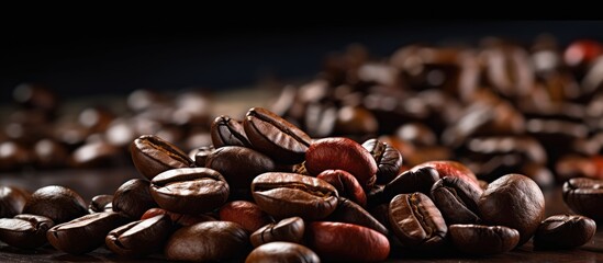 Dark background with empty space featuring coffee beans - obrazy, fototapety, plakaty