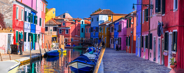Italy travel and landmarks. Most colorful places (towns) - Burano island, village with vivid houses near Venice. - 671730878