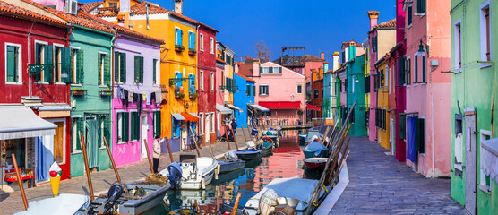 Italy travel and landmarks. Most colorful places (towns) - Burano island, village with vivid houses near Venice. - obrazy, fototapety, plakaty