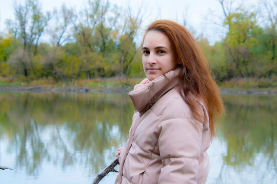 Young woman in autumn at the lake of Dany
