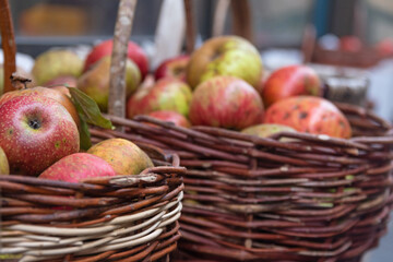 Baskets of apples in a street fruit shop. Defocused background