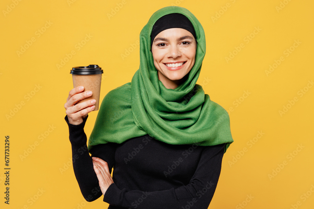 Wall mural young arabian asian muslim woman wears green hijab abaya black clothes hold takeaway delivery cup co