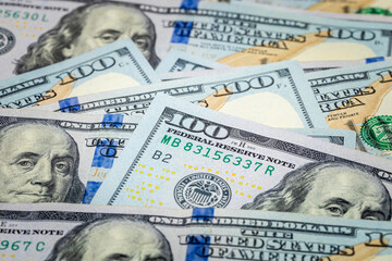 Fragment of a 100 US dollar banknote of the new design, close-up. Lots of cash banknotes of 100 american dollars. Wealth concept. Background or texture
