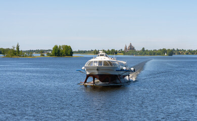 Tourist motor ship Meteor hydrofoils floating on Lake Onega against the background of the Kizhi...