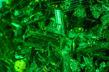 Green crystal mineral stone. Gems. Mineral crystals in the natural environment. Texture of precious and semiprecious stones. Seamless background with copy space colored shiny surface of precious stone
