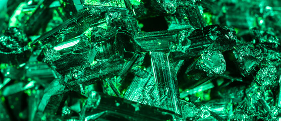 Green crystal mineral stone. Gems. Mineral crystals in the natural environment. Texture of precious and semiprecious stones. Seamless background with copy space colored shiny surface of precious stone