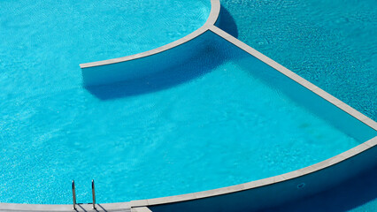 Turquoise and blue colored swimming pool which has two parts, one part is sweet water, the other salty water