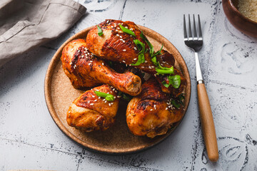Chicken drumsticks with sesame seeds, Asian cooked chicken on the table