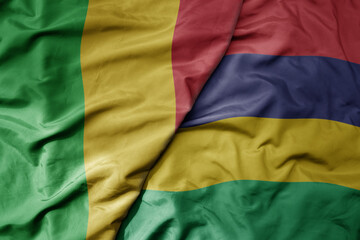 big waving national colorful flag of mali and national flag of mauritius .