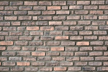 Brick wall facade. Abstract background photo. Lovely plastic texture facing on the building. Possible to use as pattern background. Ideal to place text.