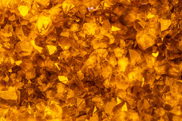 Naklejka na ściany i meble Golden crystal mineral stone. Gems. Mineral crystals in the natural environment. Texture of precious and semiprecious stones. Seamless background with copy space.