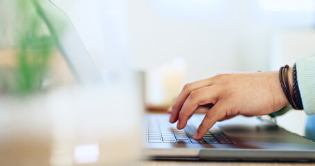 Hands, typing and man with remote work on laptop, desk and closeup on workplace in home. Computer, keyboard and person writing SEO, copywriting or working online with email marketing on the internet