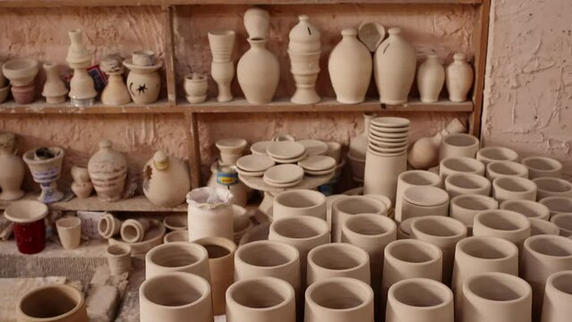 Various ceramic containers for sale. Choice of vase and pots created by clay at pottery workshop. Concept of handicraft business.